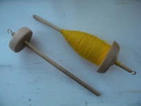 A soon to be growing spindle collection along with a full cop of merino singles in need of plying.